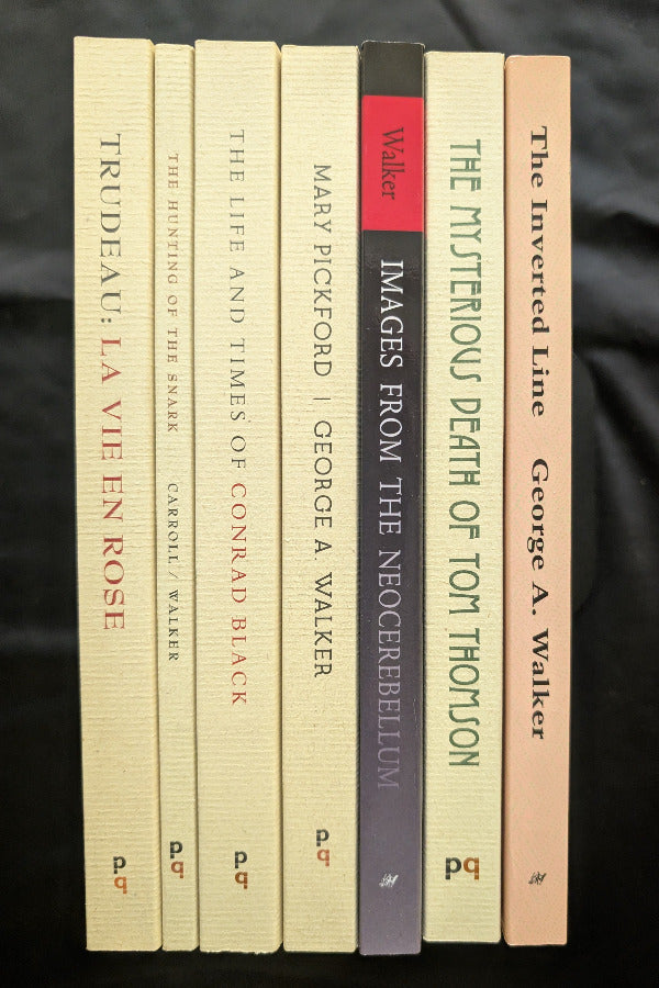 Stack of books with visible titles and authors on a dark background